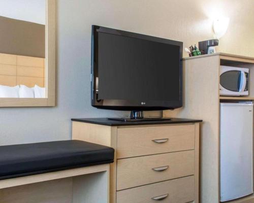 a flat screen tv sitting on top of a dresser at Quality Inn in Geneseo