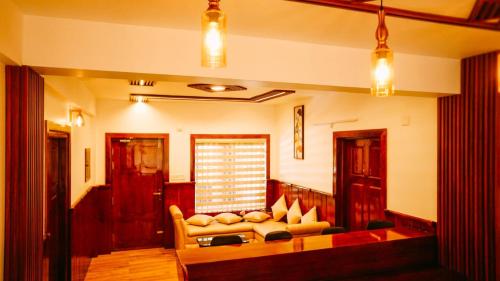 a living room with a couch and a table at Kanavu Valley View in Ooty