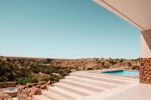 a set of stairs leading up to a swimming pool at Leeuwkuil Lodge in Philipstown