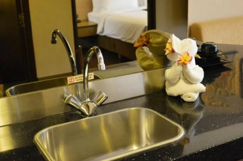 a kitchen counter with a sink and a mirror at Hotel Pacific Suites Near IGI Airport Delhi in New Delhi