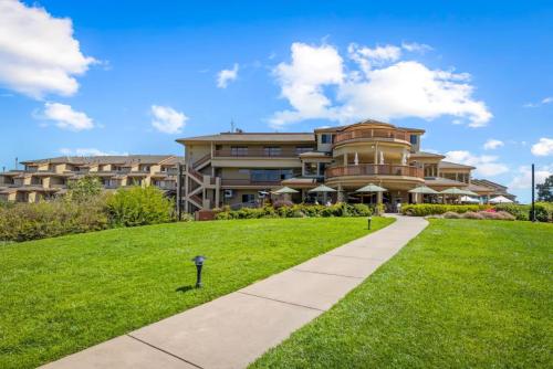 a large apartment building with a sidewalk in front of it at Luxury Ocean View Condo - Heated pool and Spa condo in La Selva Beach