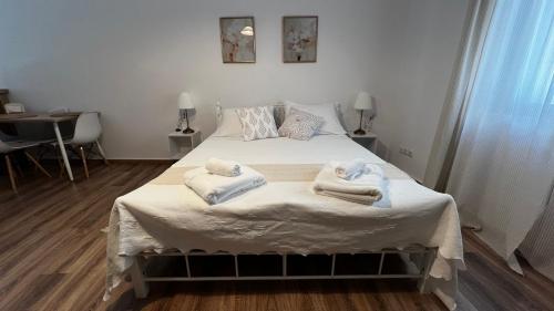 a bedroom with a bed with towels on it at Cloud9Rest & Fly in Koropíon