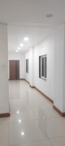 a large empty room with white walls and a door at Hotel zova in Karīmnagar