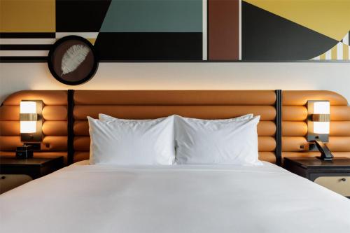 a bedroom with a large bed with white pillows at Hyatt Centric Chicago Ohare in Rosemont