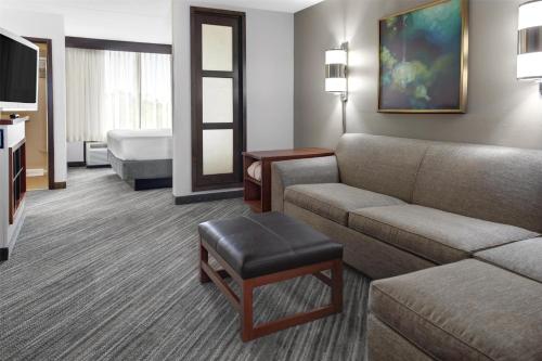 a hotel room with a couch and a bed at Hyatt Place Boise/Towne Square in Boise