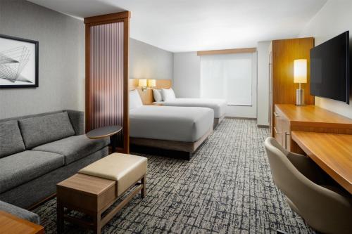a hotel room with a bed and a couch at Hyatt Place Canton in Lake Cable