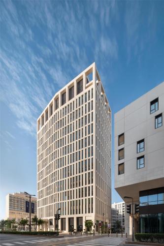 a tall white building with a lot of windows at Park Hyatt Doha, Msheireb Downtown in Doha