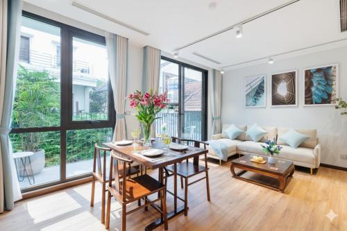 a living room with a table and a couch at Margaery Boutique Apartment & Skyon9 Rooftop Bar in Hanoi