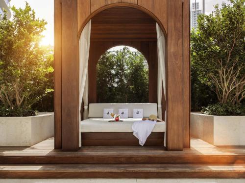 a bed in an archway with a table in it at SLS LUX Brickell in Miami