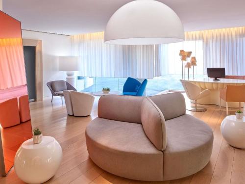 a living room with a chair and a table at Mondrian Los Angeles in Los Angeles