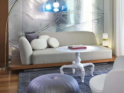 a living room with a couch and a table at Mondrian Los Angeles in Los Angeles