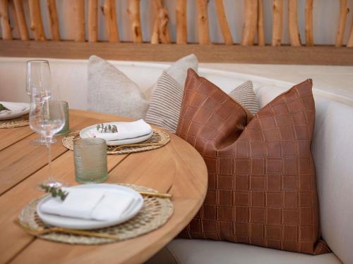 a table with plates and wine glasses on a couch at Mondrian Los Angeles in Los Angeles
