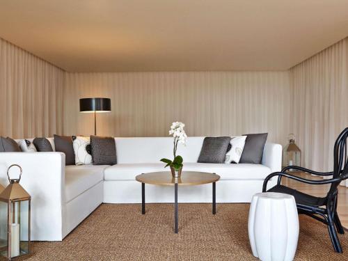 a living room with a white couch and a table at Mondrian Los Angeles in Los Angeles