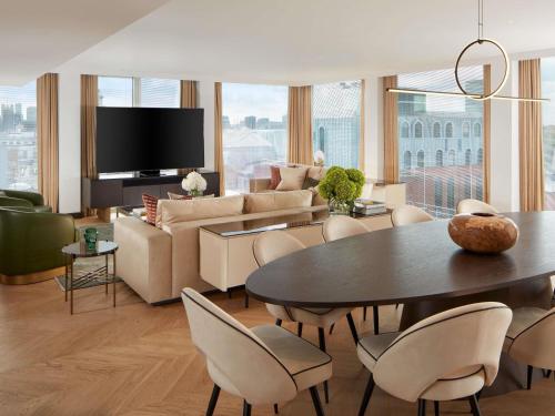 a living room with a couch and a table and chairs at St Martins Lane London in London