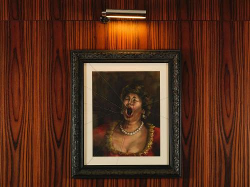 a painting of a woman with her mouth open at St Martins Lane London in London