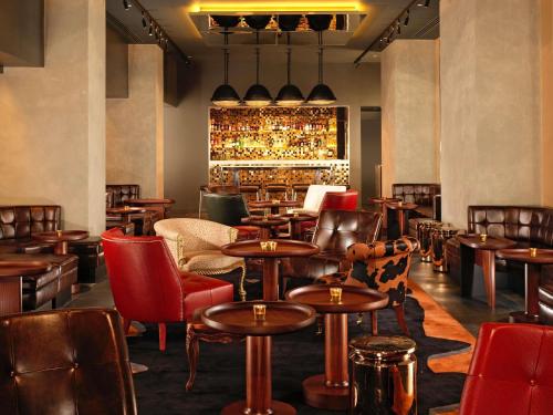 a restaurant with tables and chairs and a bar at St Martins Lane London in London