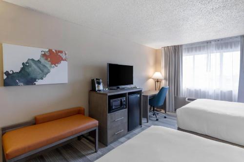 a hotel room with a bed and a television at Comfort Inn & Suites Boulder in Boulder