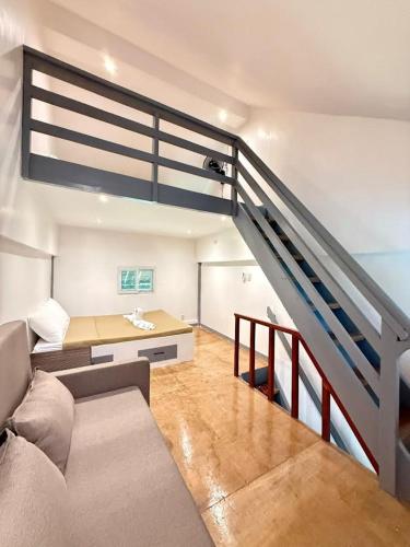 a living room with a couch and a staircase at Anaya Beach Resort - Siargao in General Luna