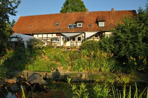 a large house with a garden in front of it at Forsthaus Wilmeröderberg in Polle