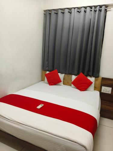 a bed with red pillows in a room at Hotel Park in Jāmb