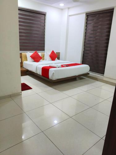 a bedroom with a bed with red pillows on it at Hotel Park in Jāmb
