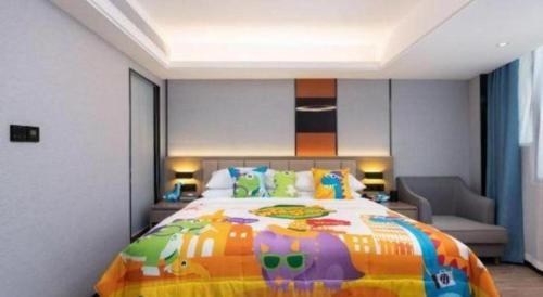 a bedroom with a large bed with a colorful bedspread at Nanning Prince Hotel in Nanning