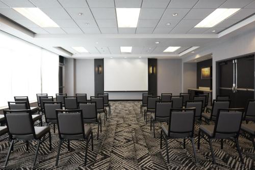 a conference room with chairs and a whiteboard at Hyatt Place New York Yonkers in Yonkers