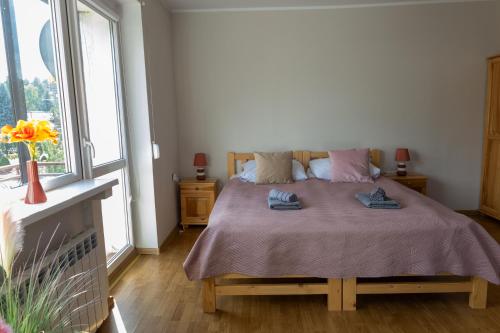 a bedroom with a bed with two towels on it at Apartament Wypoczynkowy Tuchola in Tuchola