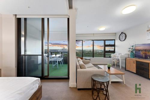 a hotel room with a bed and a living room at Best location apartment in Olympic park in Sydney