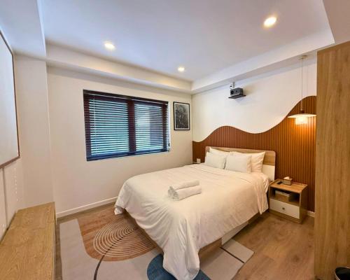 a bedroom with a large bed and a window at LYLAC Home Saigon NTMK - City Center Spacious Modern Townhouse Roof Terrace in Ho Chi Minh City