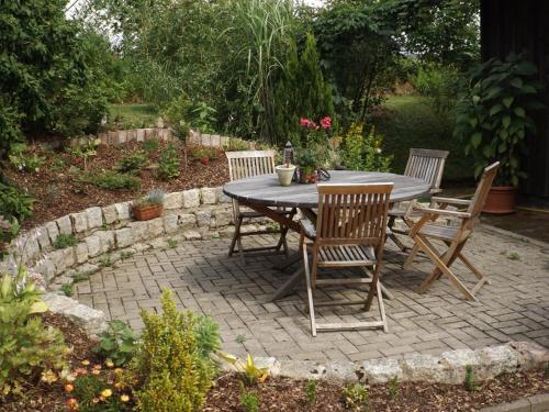 a table and chairs sitting on a brick patio at Ferienwohnung Lippert in Pullenreuth