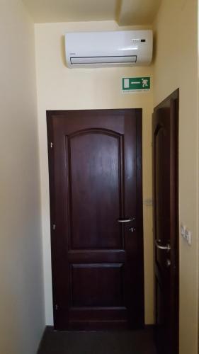a wooden door in a room with a door sidx sidx sidx at Hostel Kristal in Vinkovci