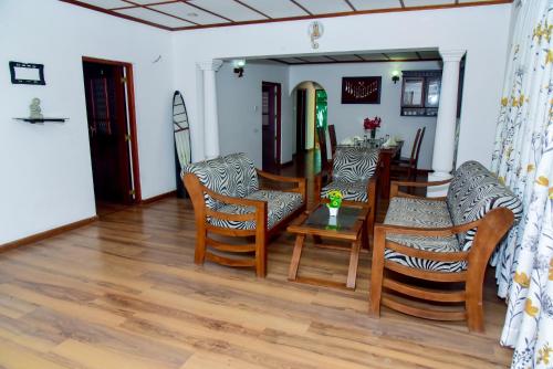 a living room with a table and chairs at Villa Thotiya in Aluthgama
