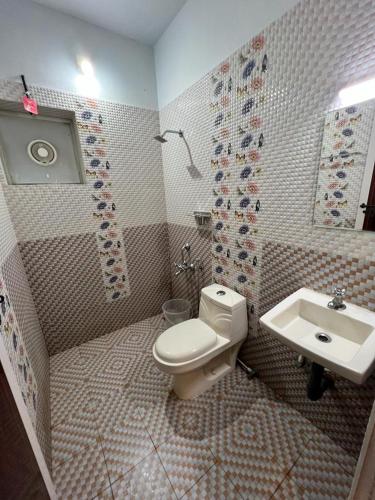 a bathroom with a toilet and a sink at Confident Residency in Guruvāyūr