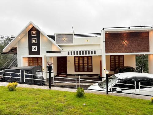 a house with a car parked in front of it at Nature View Home Stay in Vagamon
