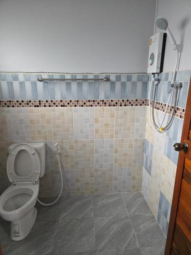a bathroom with a toilet and a shower at จันผารีสอร์ท By NLG in Ban Khok Khian