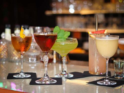 a group of different cocktails sitting on a bar at Greet Hotel Lyon Confluence in Lyon