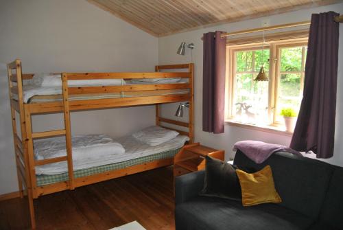 a living room with a bunk bed and a couch at Orsastuguthyrning - Stenberg in Orsa