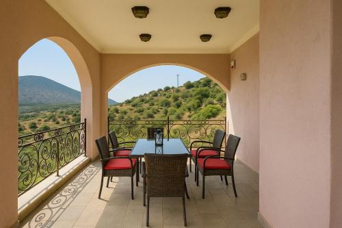 a balcony with a table and chairs with a view at Filistron Seaview Bliss - Coastal Secluded Gem in Taktikoúpolis