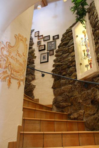 a staircase in a building with a stone wall at Andi's Skihotel in Obertauern