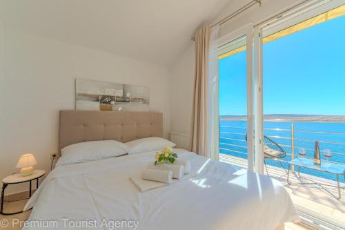 a bedroom with a bed with a view of the ocean at Villa Mia in Kustići