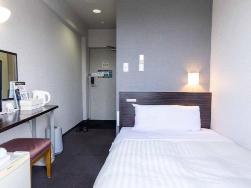 Ένα ή περισσότερα κρεβάτια σε δωμάτιο στο Super Hotel Matsusaka