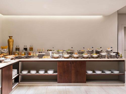 a kitchen with a counter with many pots and pans at Shaden Resort in AlUla