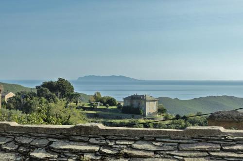 a stone wall with a view of the ocean at Tour Barrigioni in Sisco