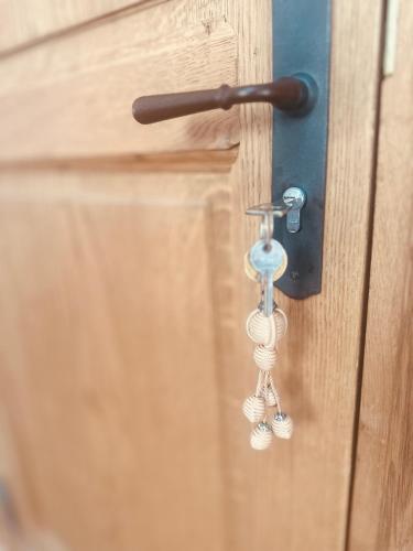 ajar door with a keychain hanging from a door knob at L appartement de Manon, centre historique du vieil Antibes in Antibes
