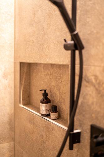 a bottle of soap sitting on a shelf in a bathroom at Fürmesli Appartements in Lech am Arlberg