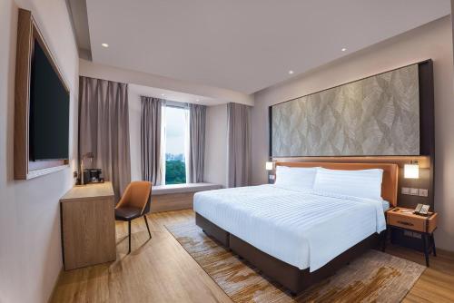 En eller flere senge i et værelse på Wyndham Singapore Hotel