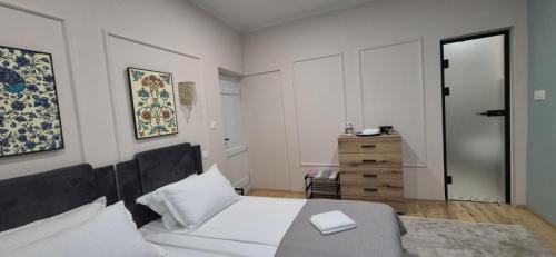 a bedroom with a bed and a dresser at Mihail Residence - Relax in Kavala in Kavala