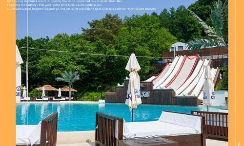 a swimming pool with chairs and umbrellas next to a swimming pool at Chuncheon bali 376 