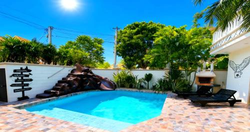 a pool with a slide in a house at POTTERLAND Luxury Pool Villa Pattaya Walking Street in Pattaya South